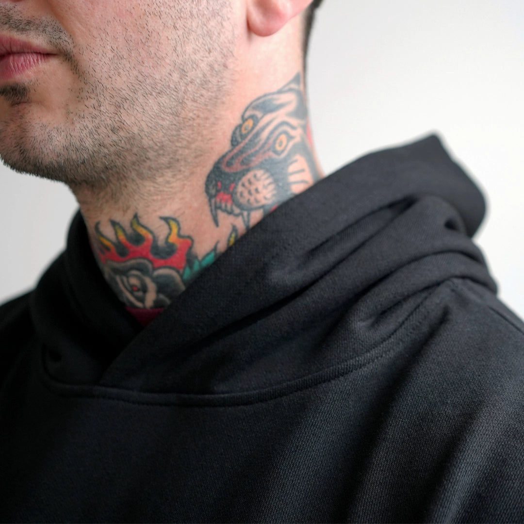 Close-up of the Hoodie in heavyweight 470GSM organic French Terry, showing the structured hood around the neck.