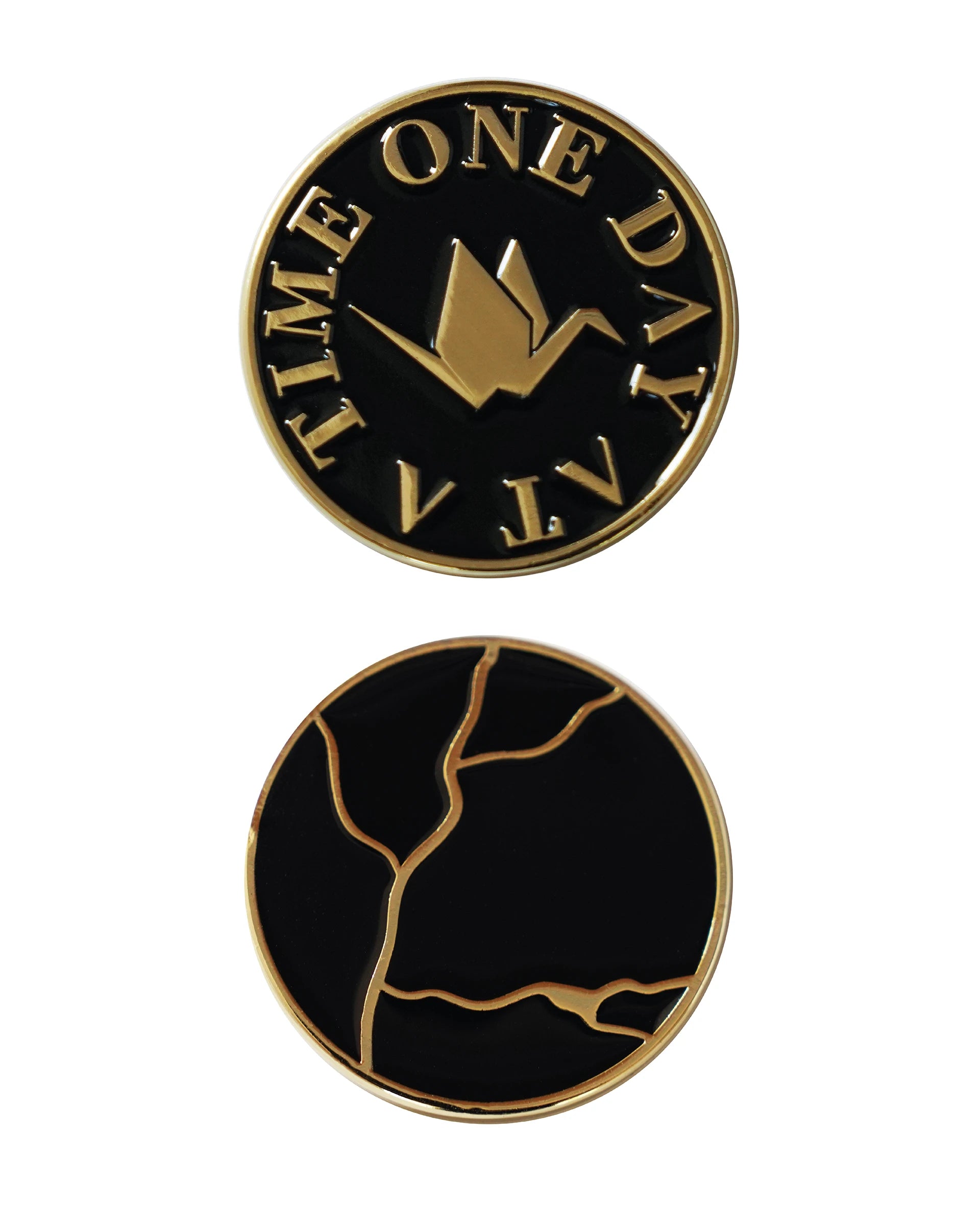 ODAAT Medallion – Kintsugi Edition, front and back view. Front side features gold origami crane with “ONE DAY AT A TIME” text on a black background; reverse side shows gold kintsugi crack design on black enamel.