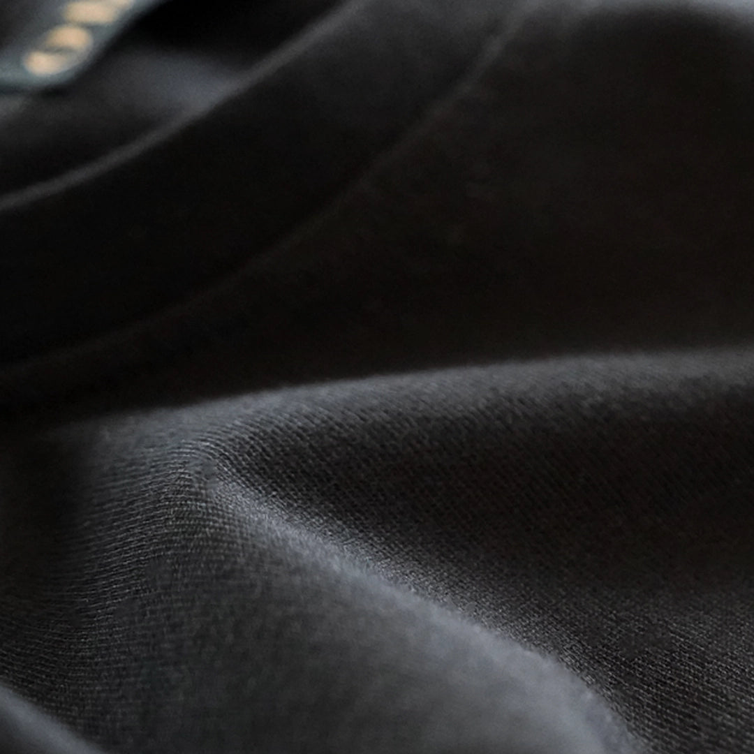 Macro close-up of ODAAT’s 100% organic cotton fabric, highlighting its soft texture and breathable, durable quality for everyday wear.