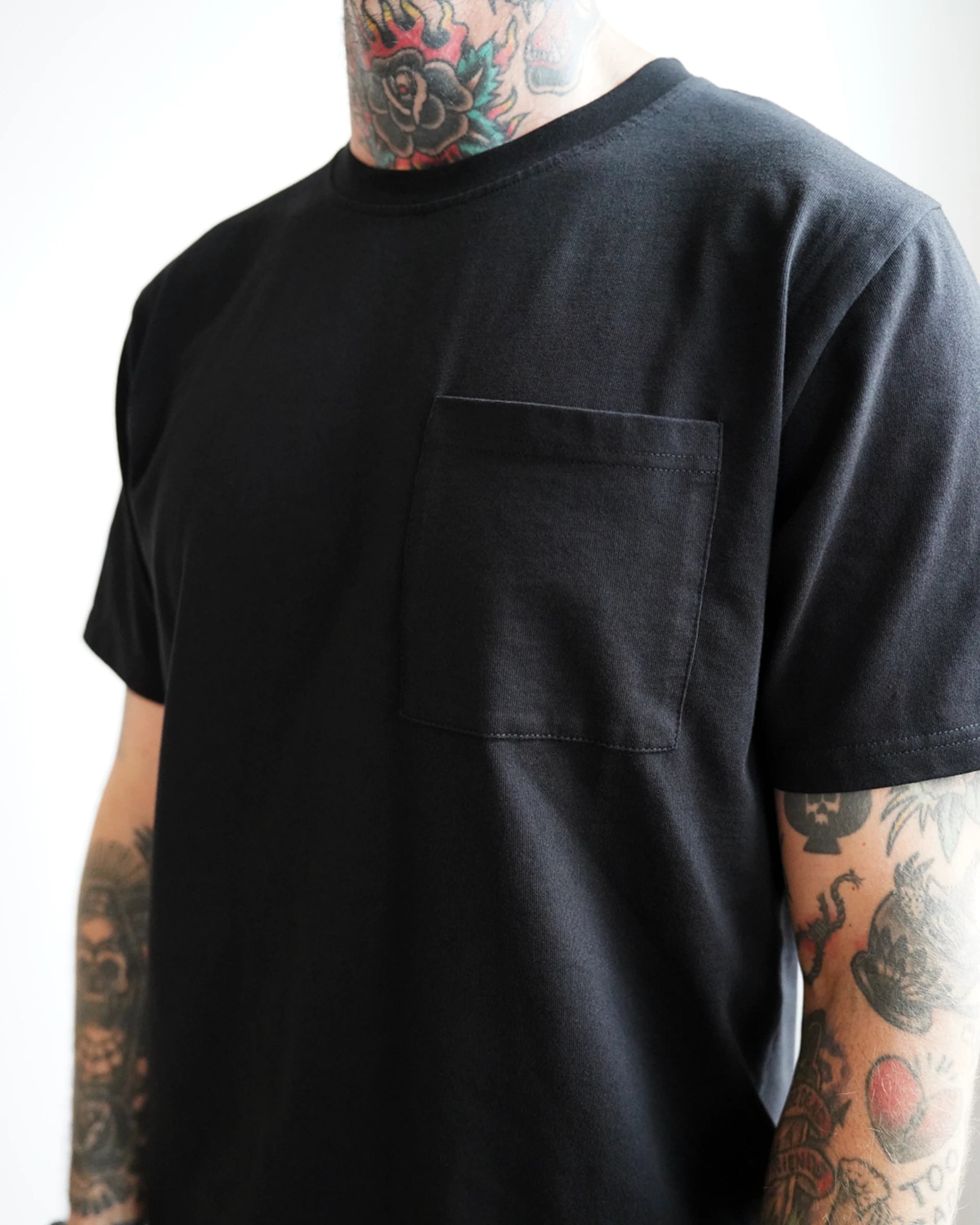 Front view of the ODAAT “One Day At A Time” Script Tee in black, featuring a clean chest pocket and minimalist design that embodies quiet strength and everyday resilience.