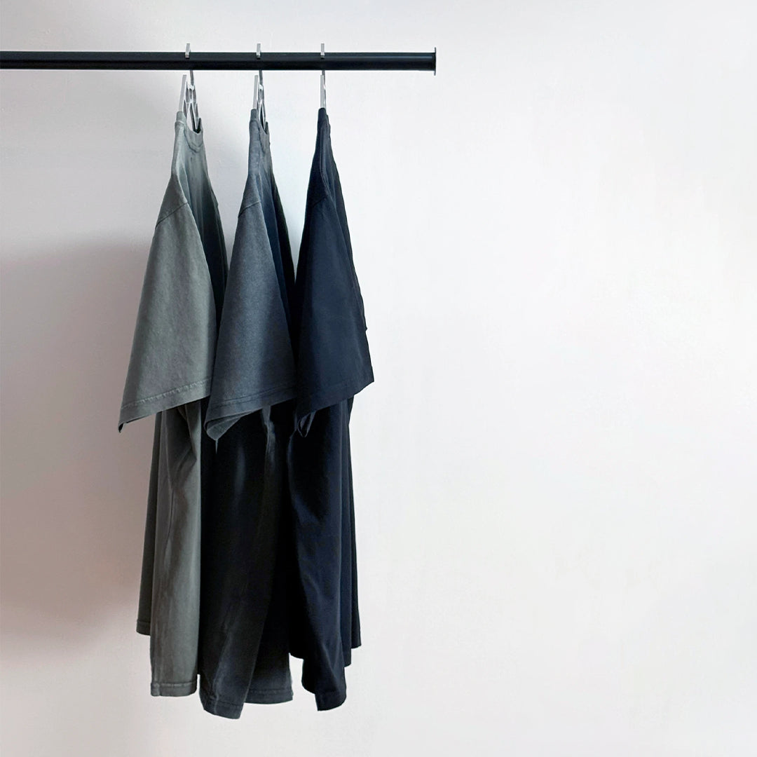 Midweight Tee in Olive, Washed Black and Black on a rail, no exterior logo
