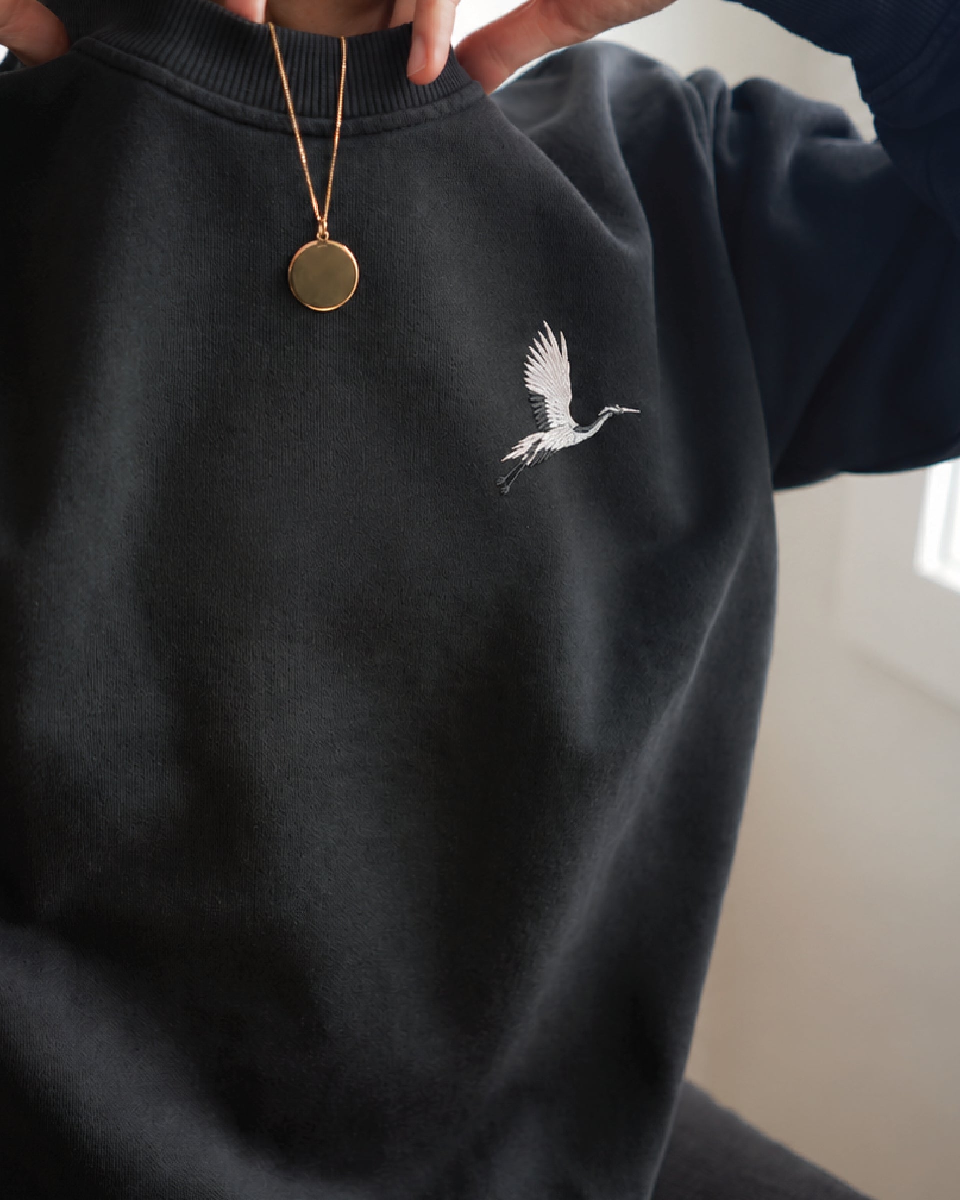 Origami Echo Crewneck in Black, crane embroidery at the chest