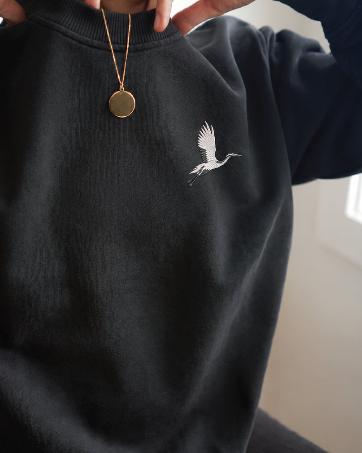Origami Echo Crewneck in Black, crane embroidery at the chest