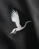 Detailed crane embroidery on black French terry