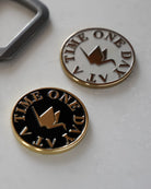 ODAAT Medallion — Kintsugi Edition in Black/Gold and Two-Tone Silver/Gold finishes, featuring crane icon and “One Day At A Time” text.