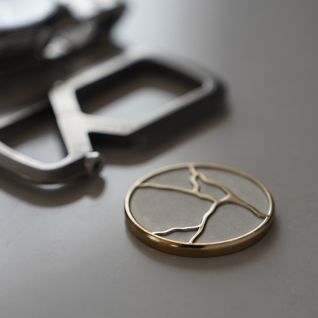ODAAT Kintsugi Medallion, Two-Tone edition. Raised gold cracks across silver back. Polished gold edge.