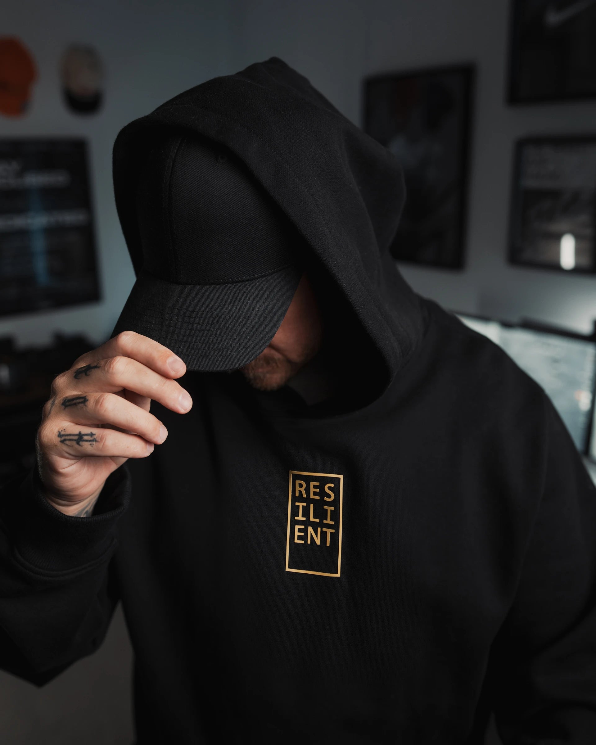 ODAAT Apparel Resilient Hoodie in black heavyweight organic cotton, gold print logo, minimal streetwear symbolizing resilience and strength.