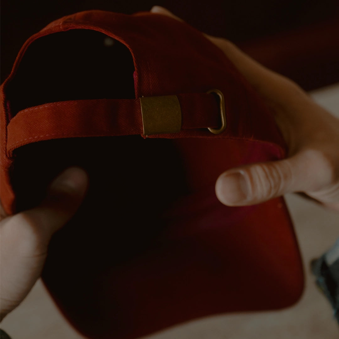 Burgundy dad cap with self-fabric strap and metal adjuster, ODAAT Signature Cap rear detail in brushed cotton.